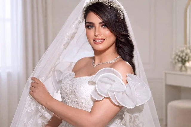 Bride with swept dark hair, tiara and sculptural white dress