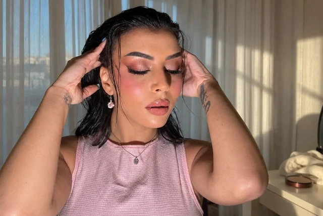 Rose shimmer makeup and wet-look dark hair