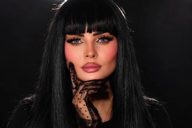 Pink evening makeup with black fringe and a lace glove