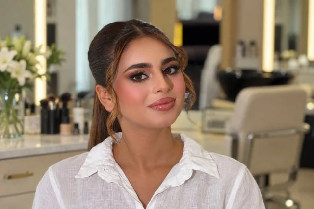 Soft brown eye makeup and face-framing curls